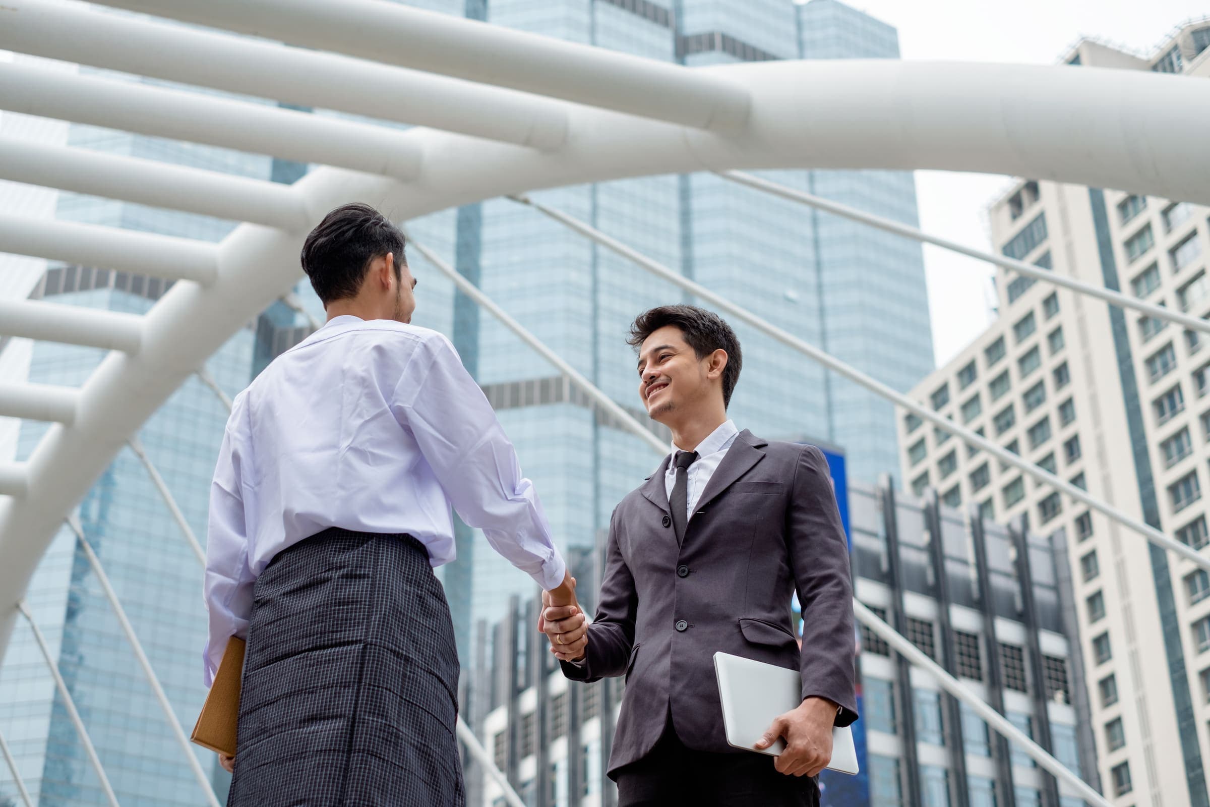 Business professionals shaking hands in an urban setting