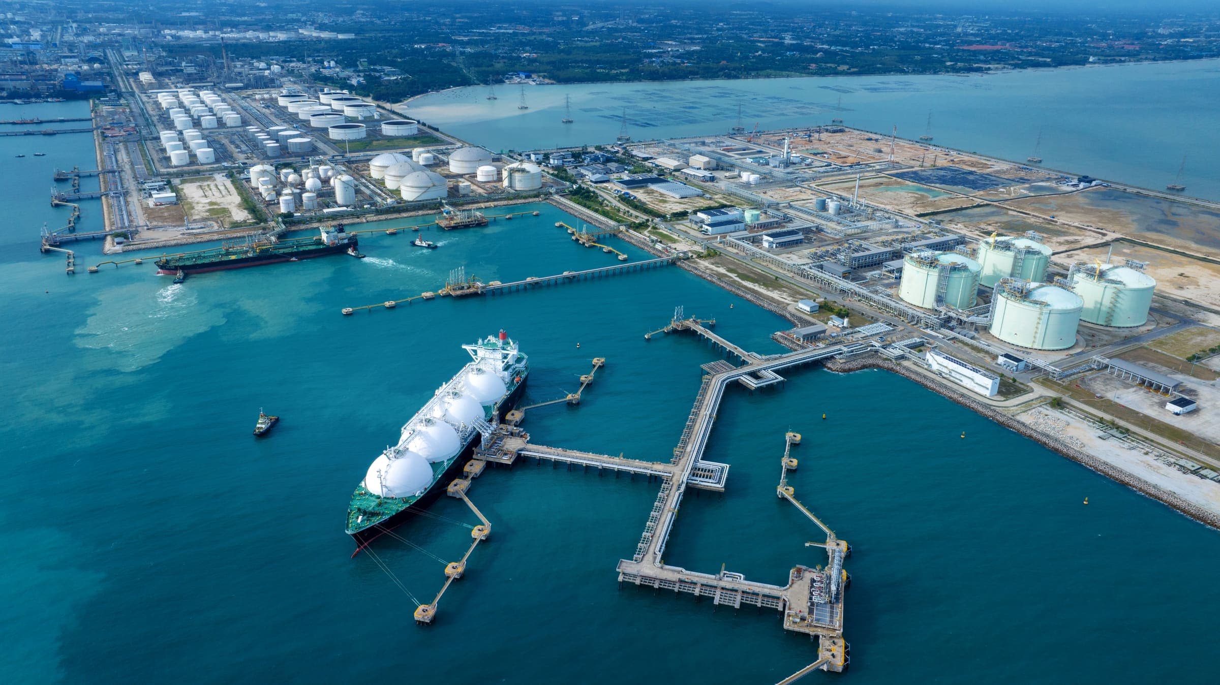 Coastal industrial complex with ships and storage infrastructure