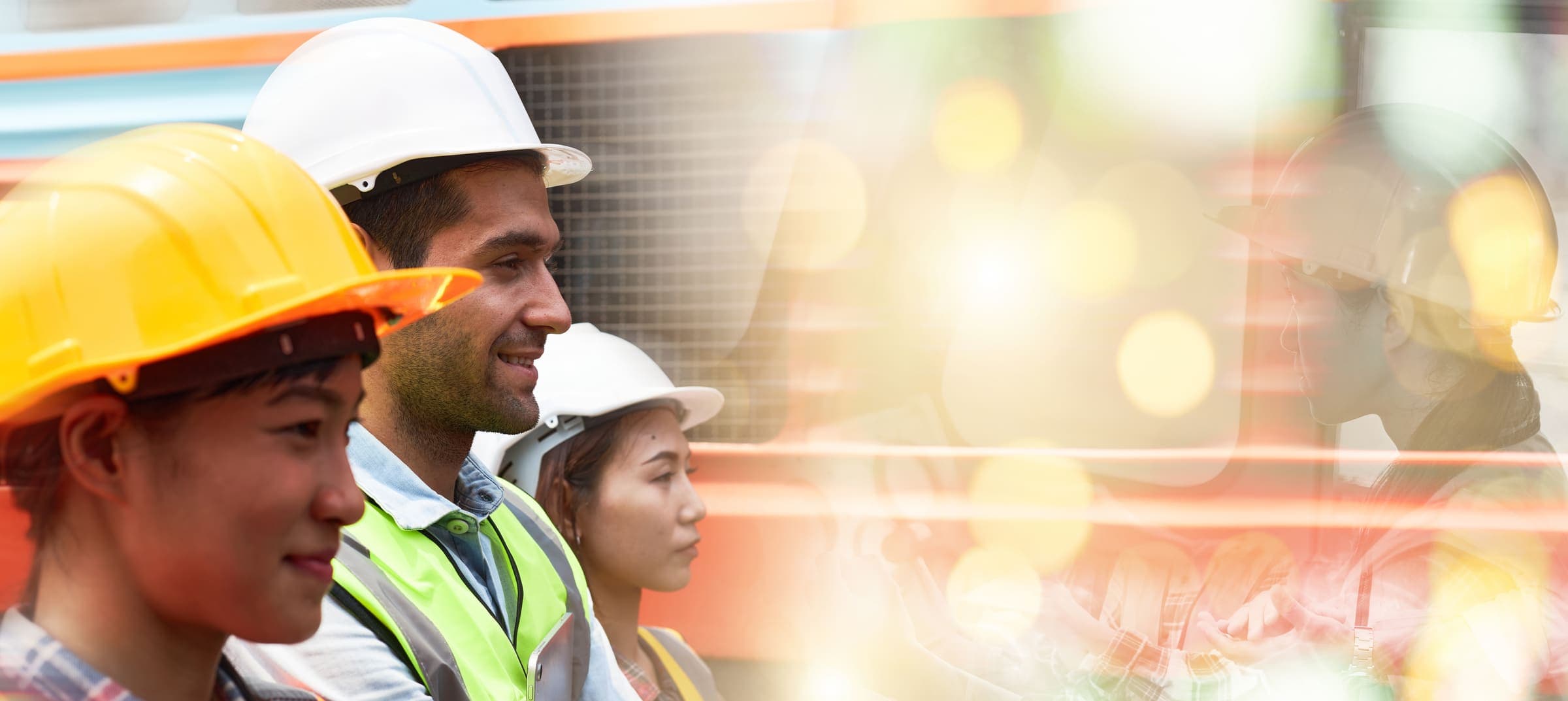 Construction workers wearing safety harnesses and hard hats on an Australian building site