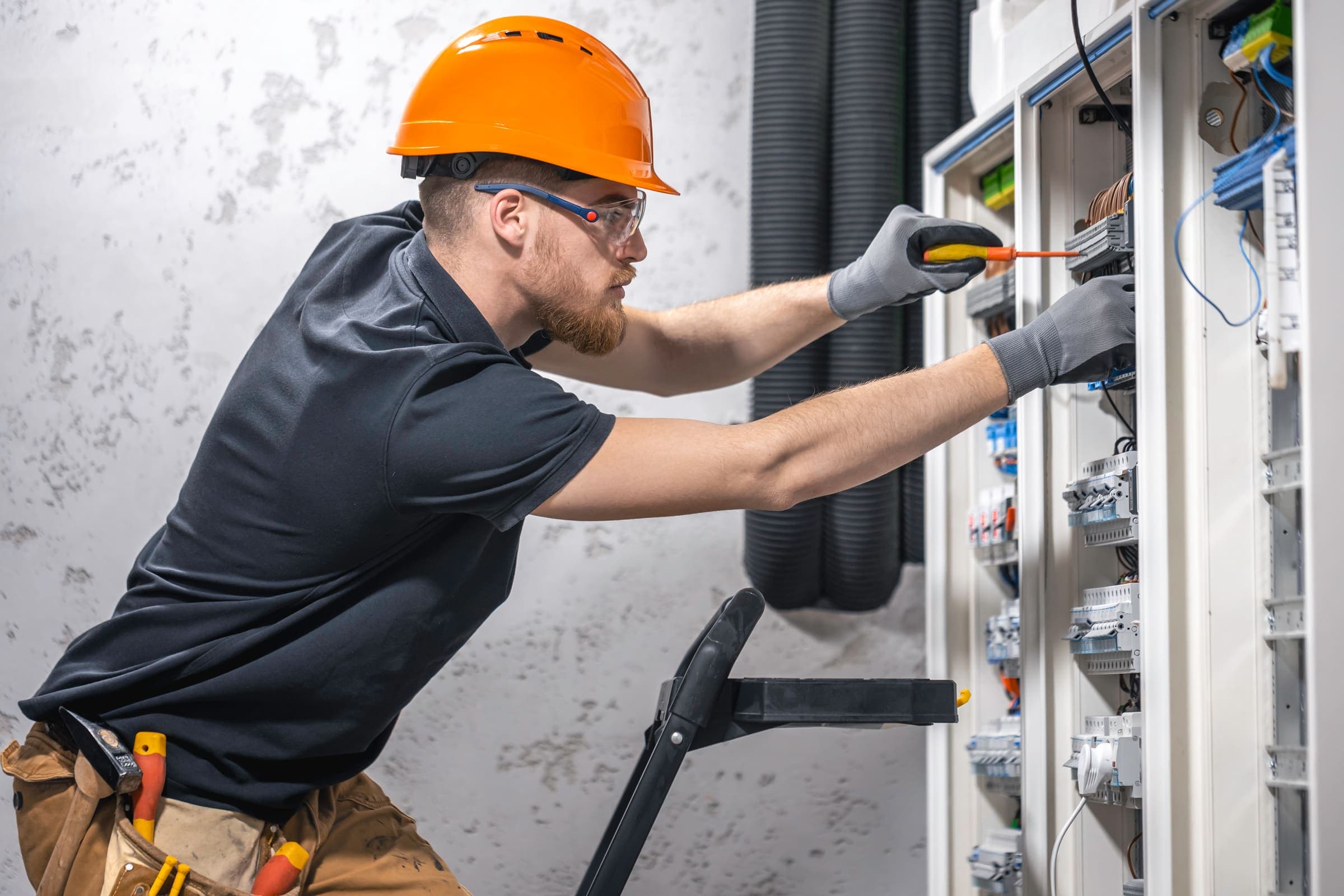 Electrical technician working on a circuit breaker panel