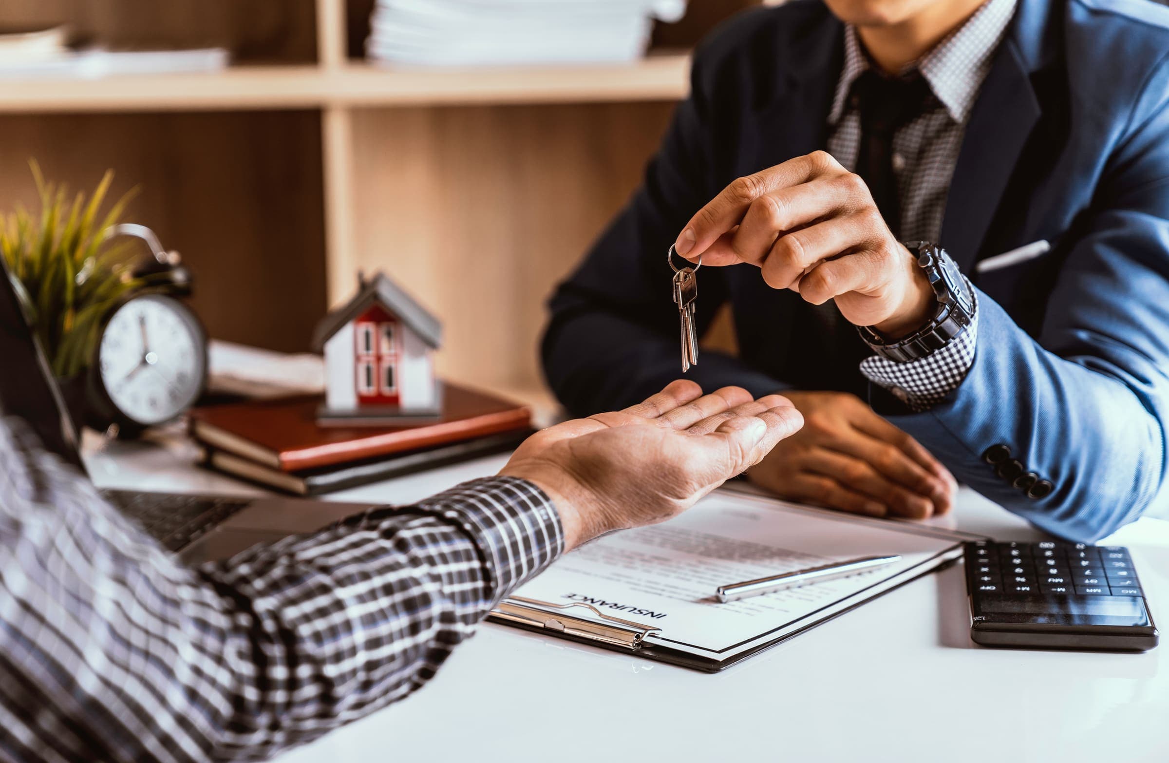 Real estate agent handing over a new set of house keys